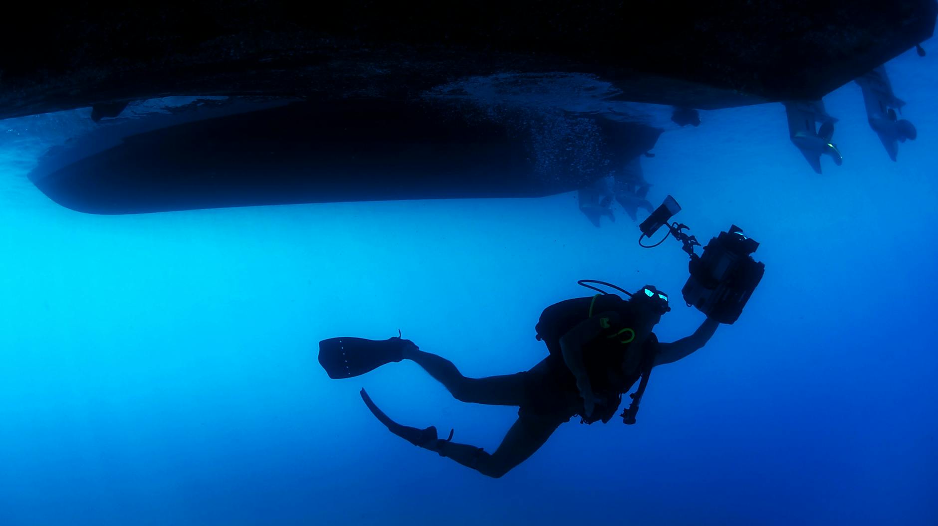 man swimming under water