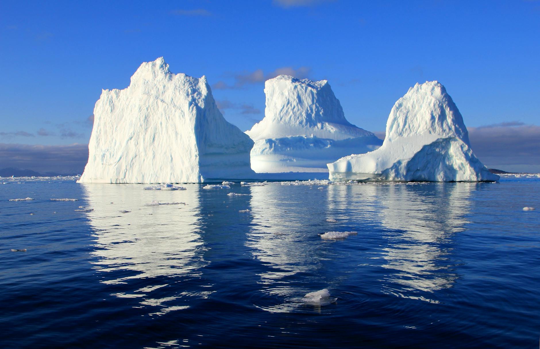 This is a picture of icebergs in the ocean. These messages are transmitted to the ships at sea to warn them of drifting icebergs