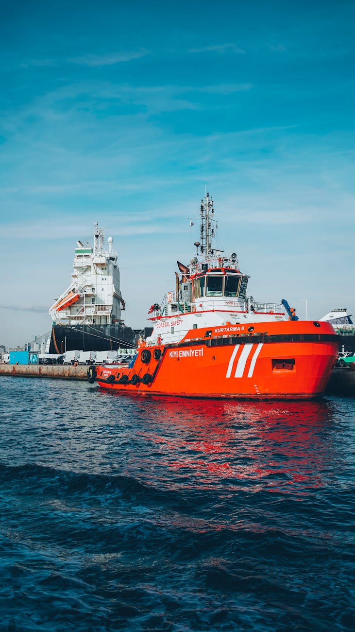 A tug boat is towing a large, unwieldy object.